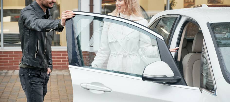 man-and-woman-at-car-dealership-buying-new-car.jpg