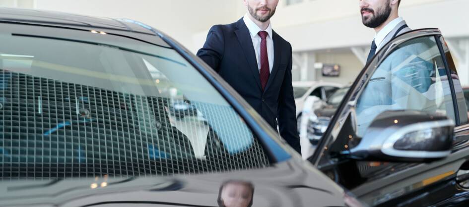 man-choosing-a-car-with-car-dealer.jpg